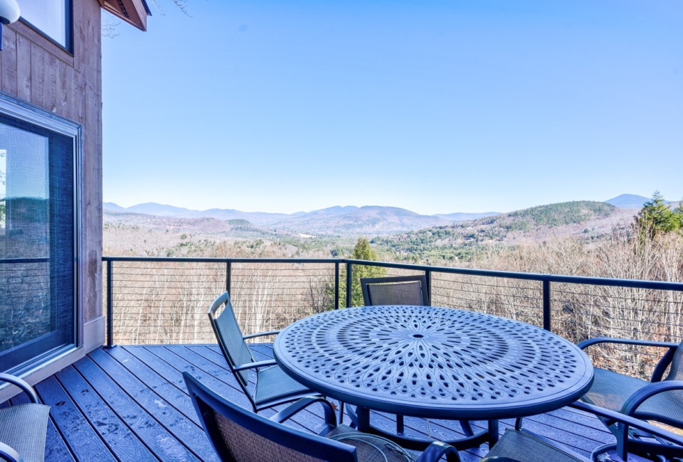 Deck with a patio table and chairs looking out over the White Mountains