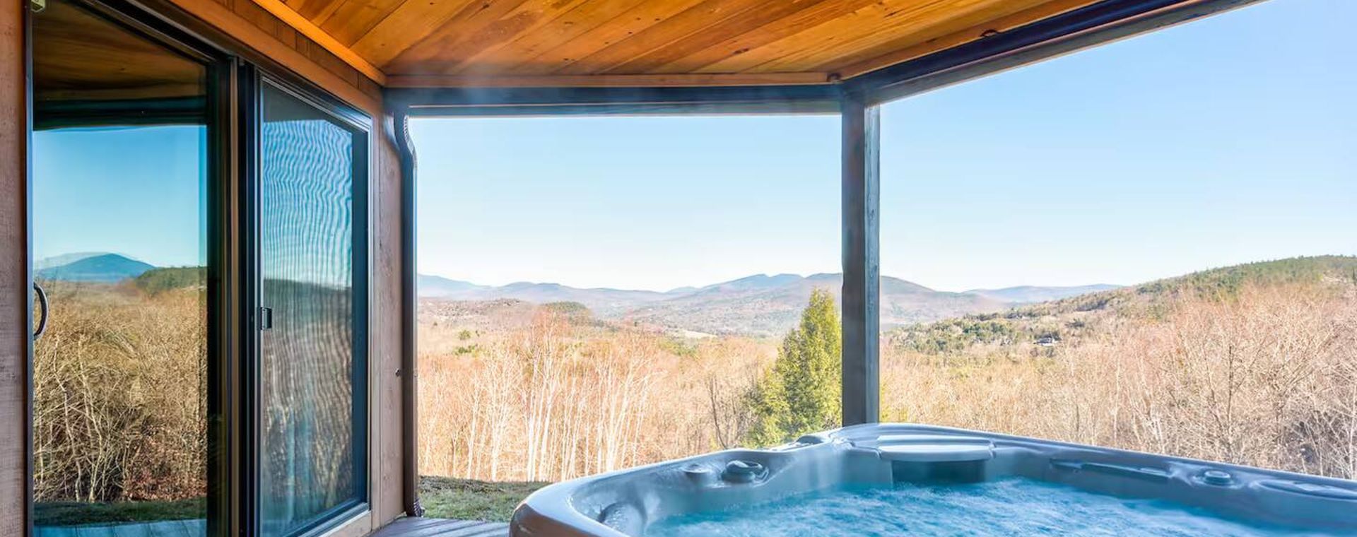 Hot tub on a mountain-view deck at a Jamie Trickett retreat in Bartlett, NH